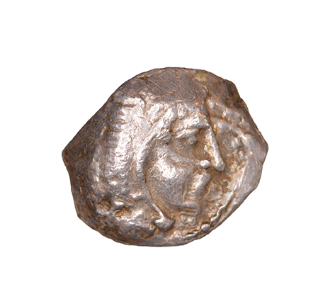 Obverse 'SilCoinCy A1055, acc.no.: KP 531.27. Silver coin of king Uncertain king of Kition of Kition 525 - 480 BC. Weight: 0.34 g, Axis: 12h, Diameter: 9mm. Obverse type: Heracles head r. unbearded with  lion skin headdress. Obverse symbol: -. Obverse legend: - in -. Reverse type: Lion devouring stag r.. Reverse symbol: -. Reverse legend: - in -. '-'.