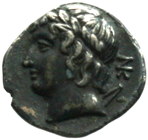 Reverse 'SilCoinCy A1867, acc.no.: . Silver coin of king Nikokreon of Salamis 331 - 310/9 BC. Weight: 2.1g, Axis: 12h, Diameter: 14mm. Obverse type: Aphrodite bust r. with turreted crown. Obverse symbol: -. Obverse legend: BA in Greek. Reverse type: Apollo head l. with laurel wreath and bow. Reverse symbol: -. Reverse legend: NK (monogram) in Greek.