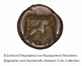 Reverse 'SilCoinCy B4, Kyrou Collection, acc.no.: ΒΠ 1989 - 4. Silver coin of king Baalmilk I of Kition 475 - 450 BC. Weight: 0.47g, Axis: 4h, Diameter: 7mm. Obverse type: Herakles head (no beard) and lion skin r.. Obverse symbol: -. Obverse legend: - in -. Reverse type: Lion seated r.. Reverse symbol: -. Reverse legend: - in -. 'Les monnaies chypriotes dans la collection d'Adonis Kyrou'.